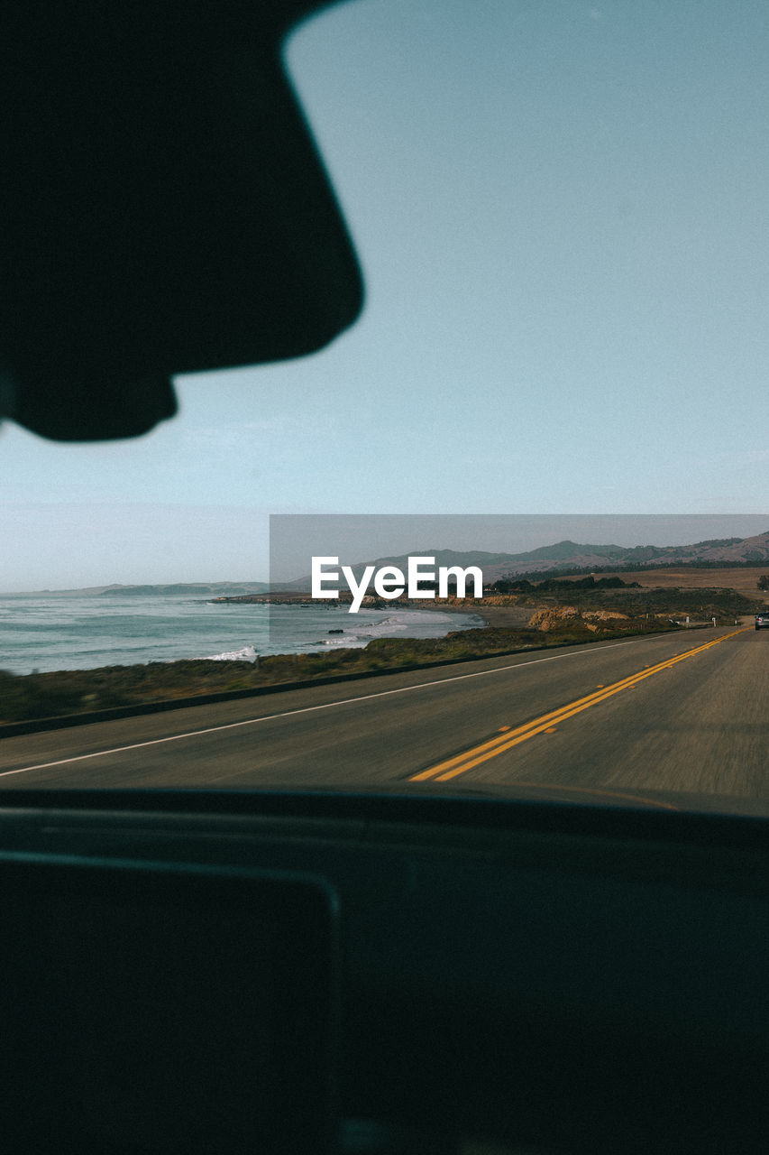 ROAD SEEN THROUGH WINDSHIELD