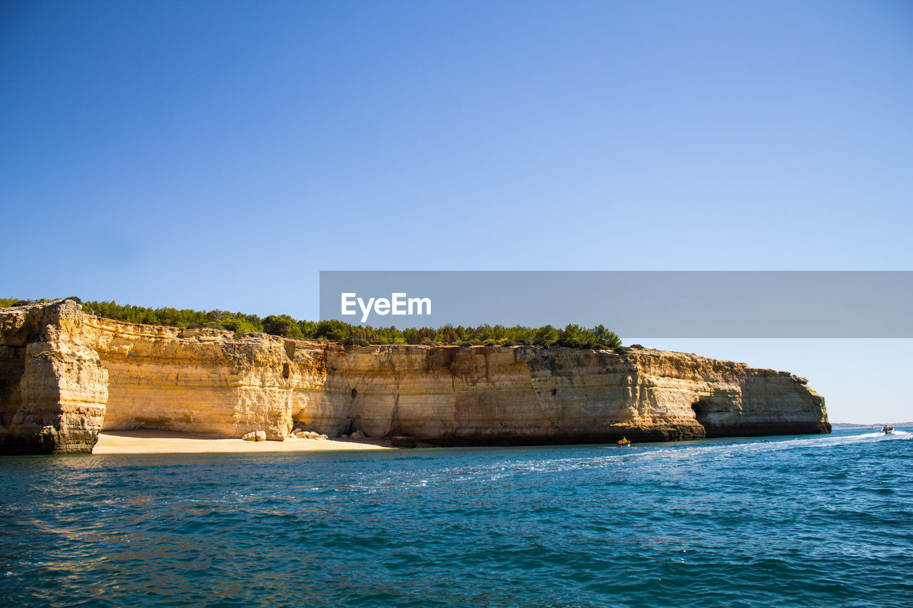 Scenic view of sea against clear blue sky