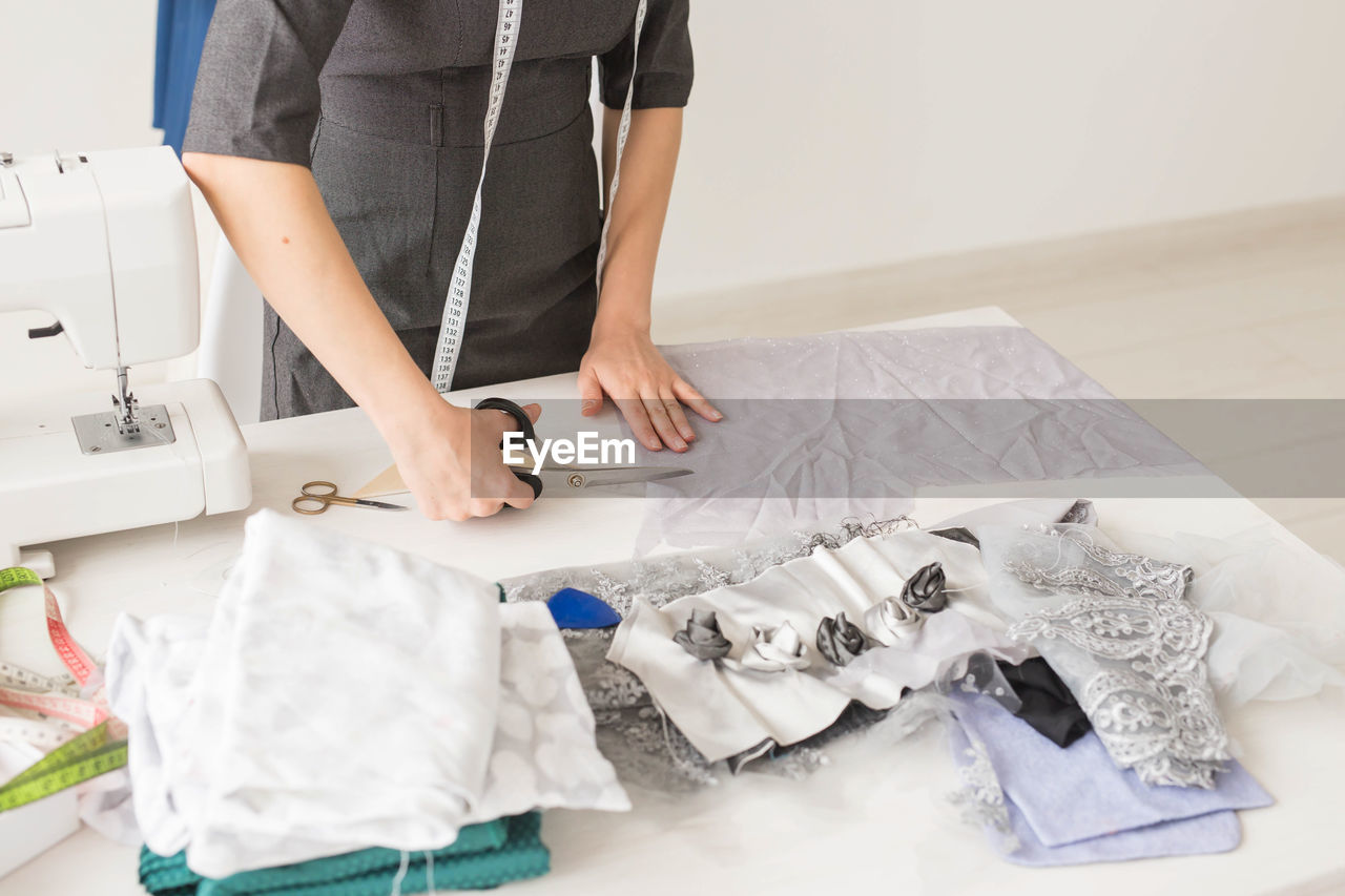 MIDSECTION OF WOMAN WORKING AT TABLE