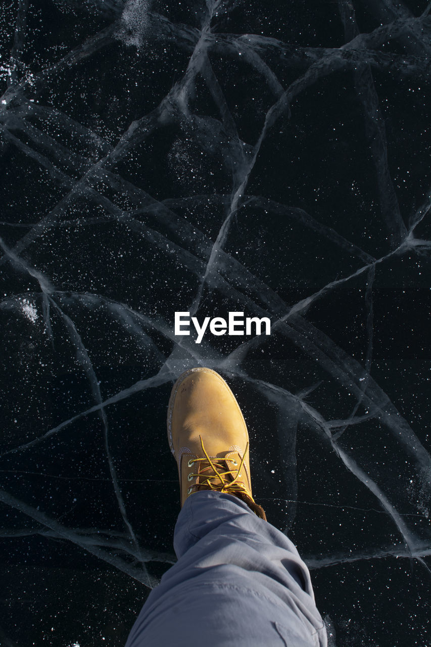 Low section of man standing on marble