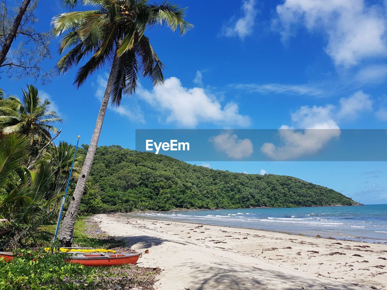 Scenic view of beach against blue sky