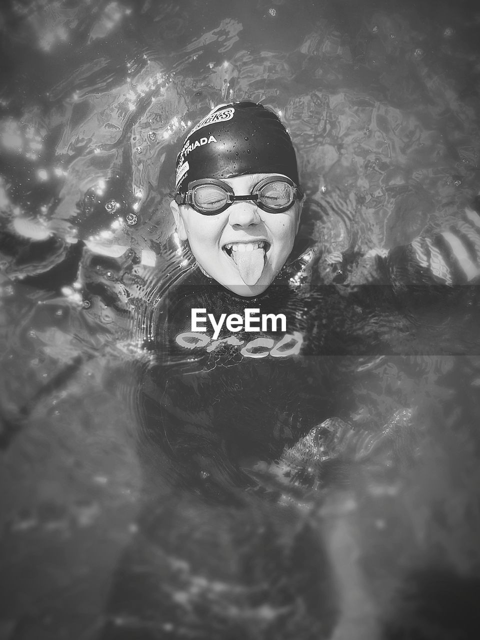 FULL LENGTH PORTRAIT OF BOY SWIMMING IN POOL