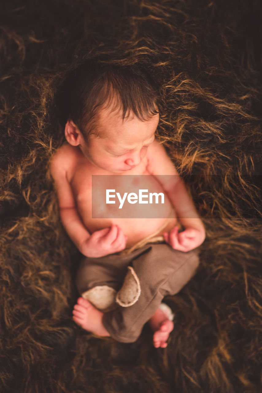 HIGH ANGLE VIEW OF CUTE BABY GIRL WITH EYES CLOSED