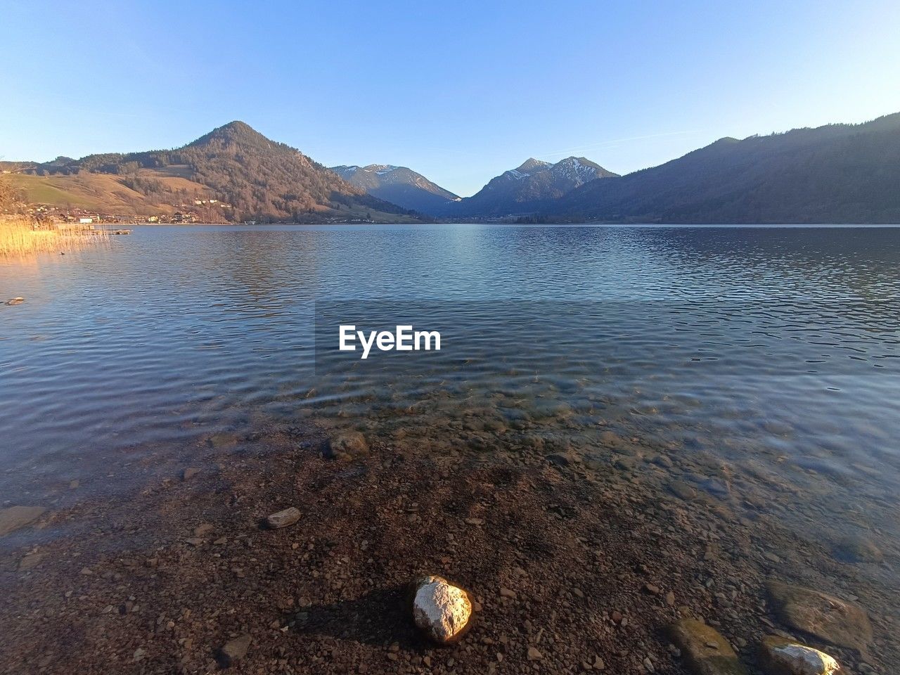 mountain, water, lake, scenics - nature, body of water, sky, landscape, beauty in nature, nature, environment, reflection, land, reservoir, mountain range, tranquility, tranquil scene, no people, travel destinations, clear sky, wilderness, shore, travel, day, outdoors, blue, animal wildlife, sunny, animal, beach, non-urban scene, morning, cloud