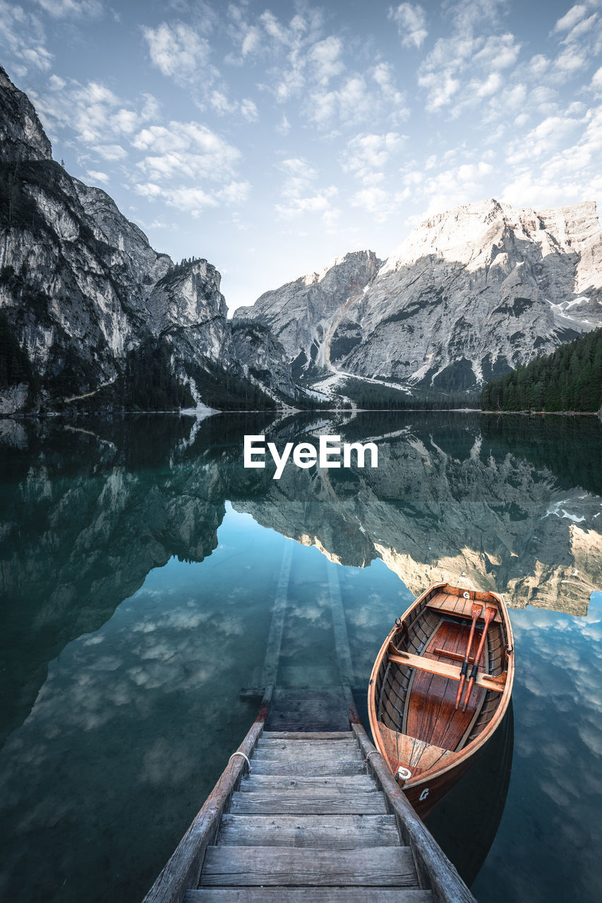 Scenic view of lake by mountains against sky