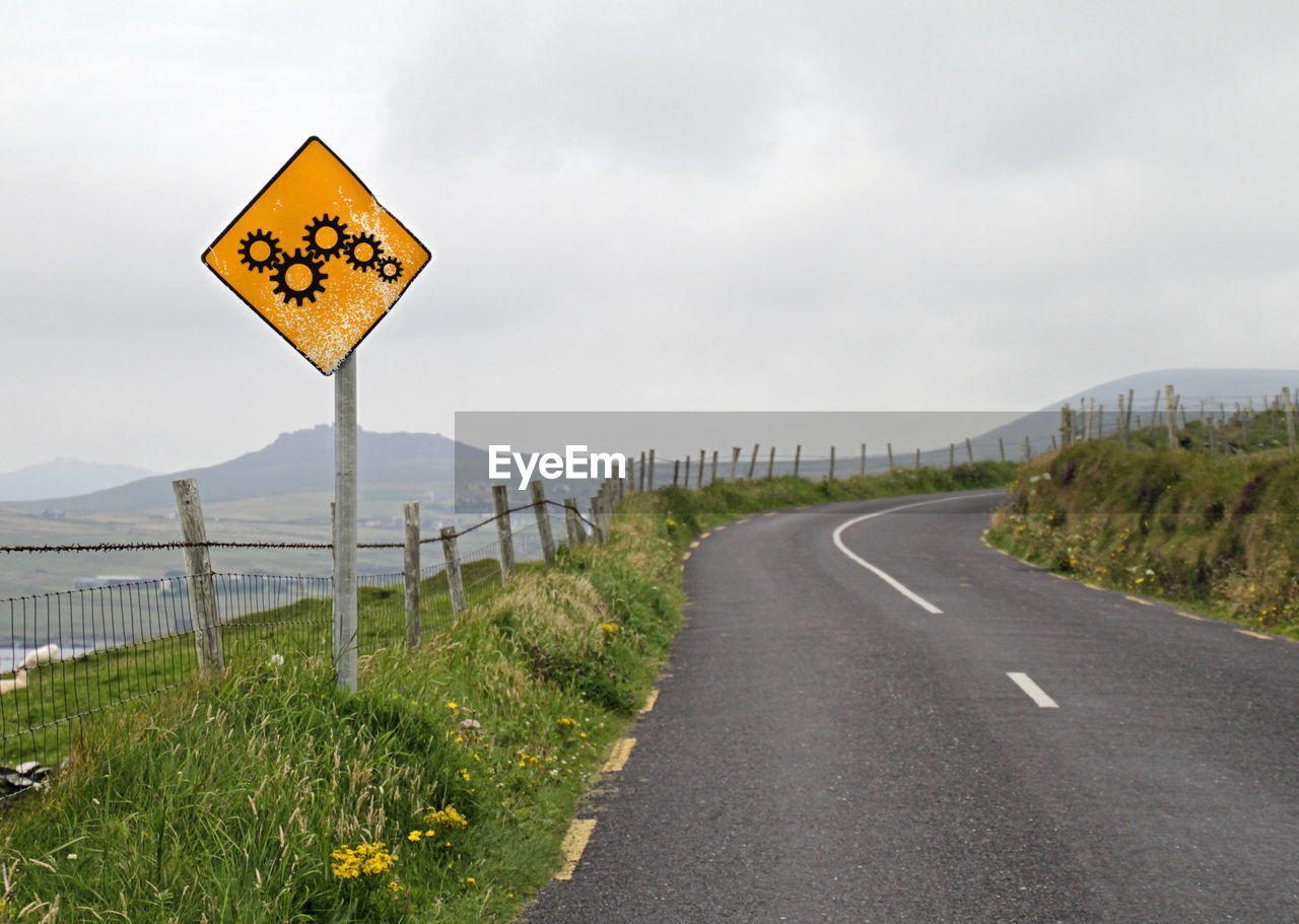 Winding road and yellow road sign - processes and change