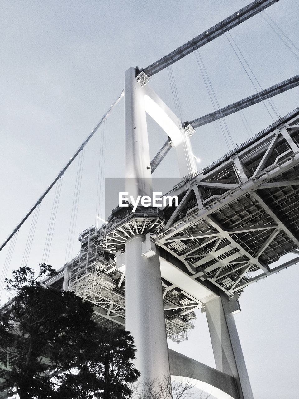 Low angle view of suspension bridge against sky