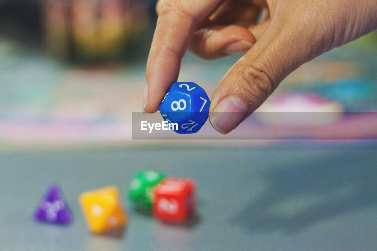 Close-up of cropped hand holding dice