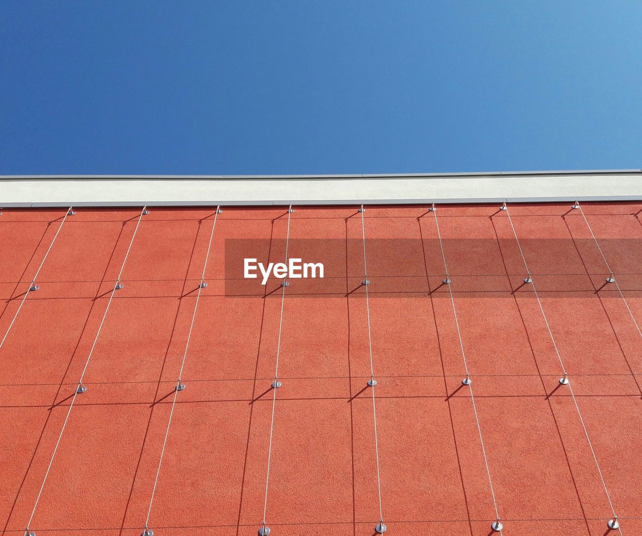 Red roof against brick wall