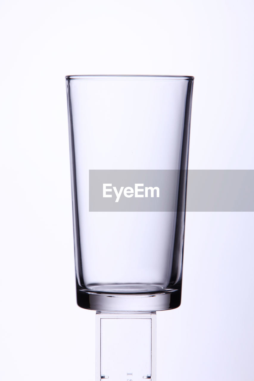 Close-up of empty glass against white background