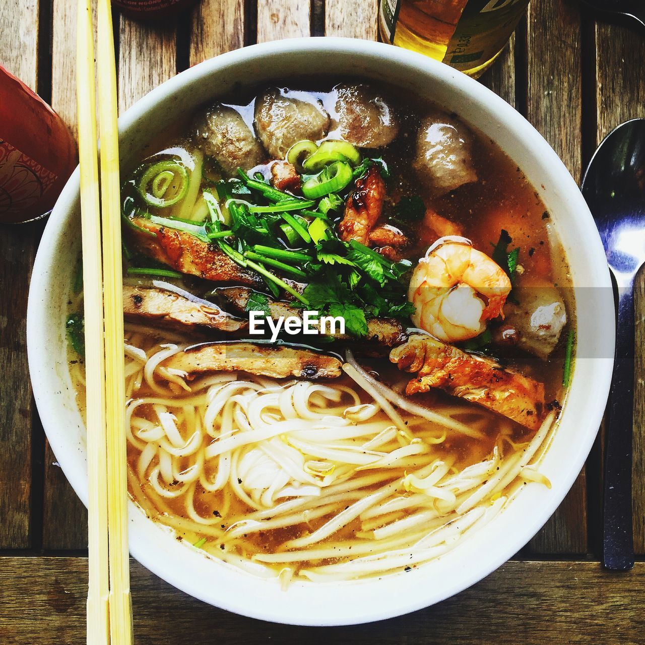 Directly above shot of ramen soup in bowl on wooden table