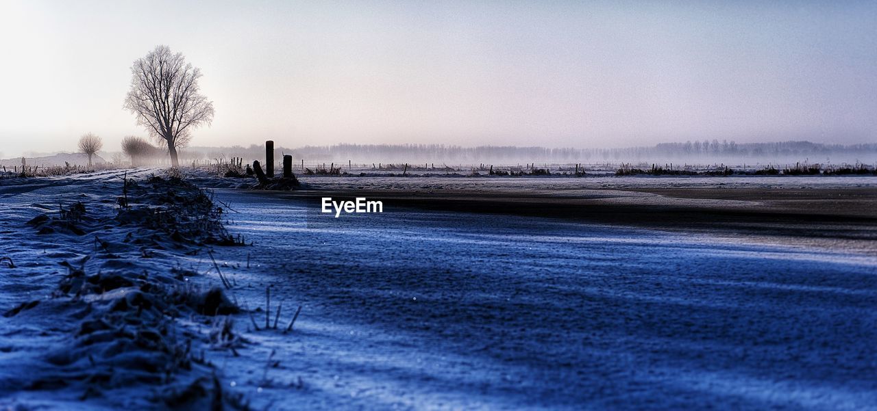 Scenic view of frozen lake against clear sky during winter