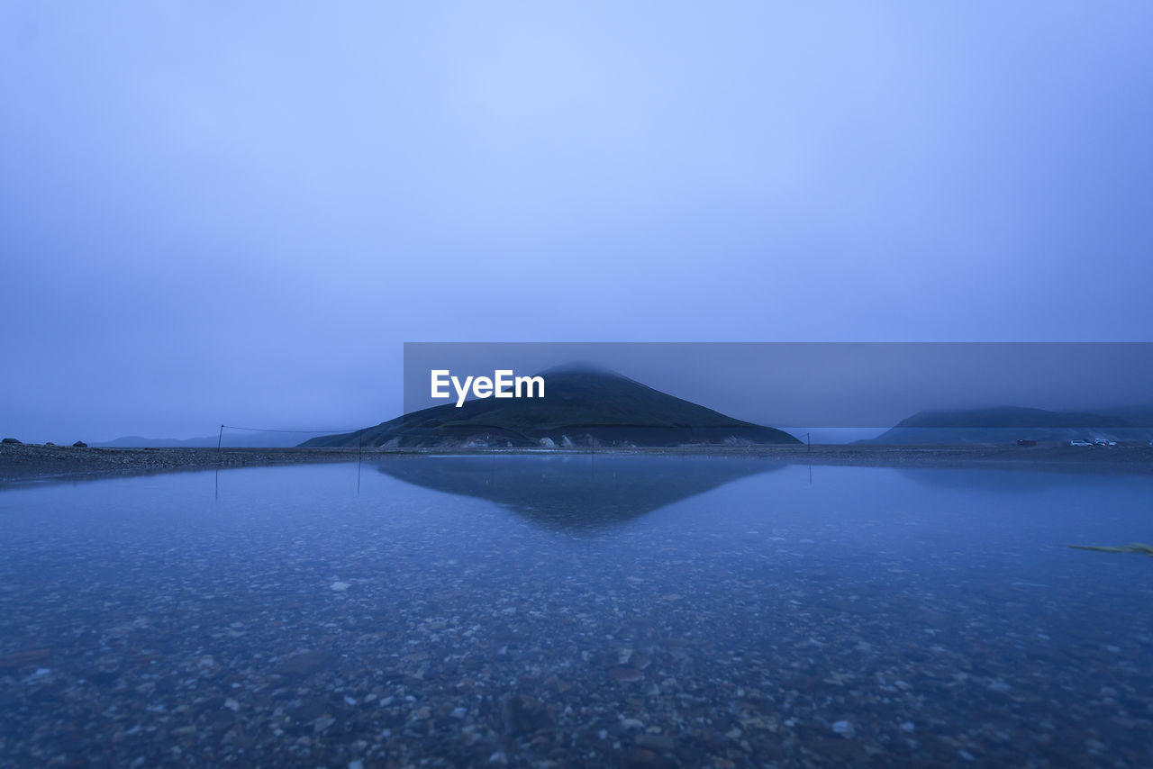 Long exposure of reflection of mountain in water at night