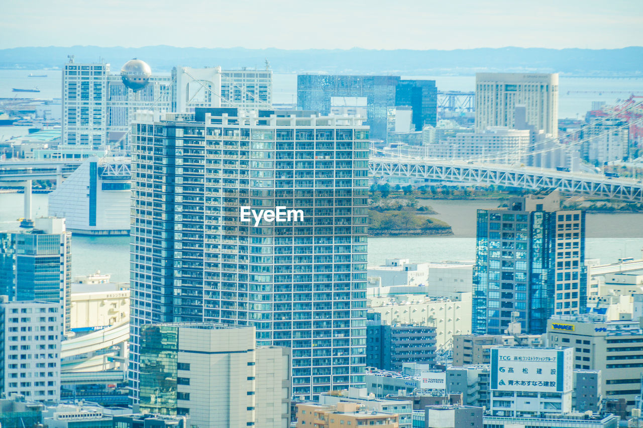 HIGH ANGLE VIEW OF MODERN BUILDINGS AGAINST SKY