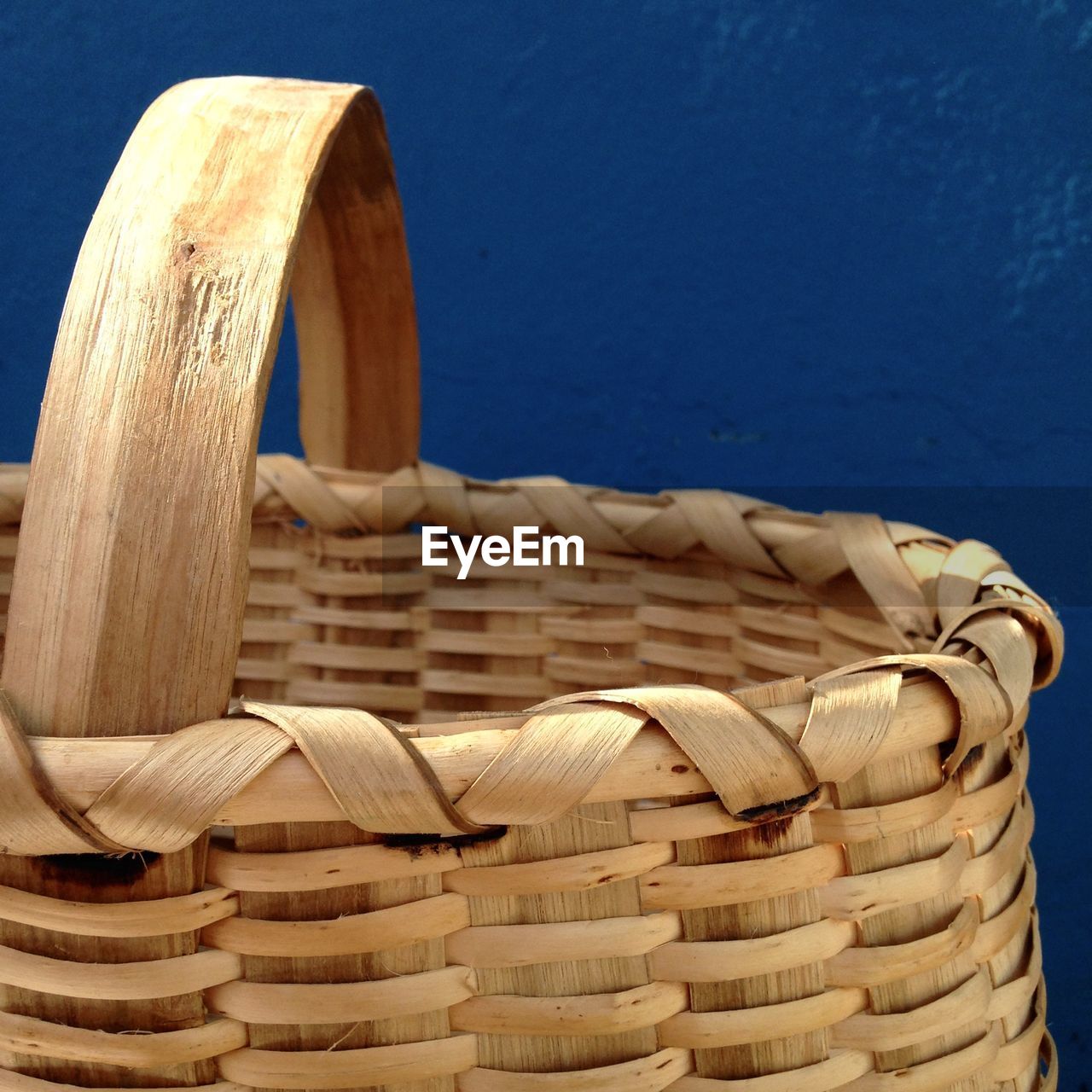 CLOSE-UP OF WICKER BASKET ON STONE WALL