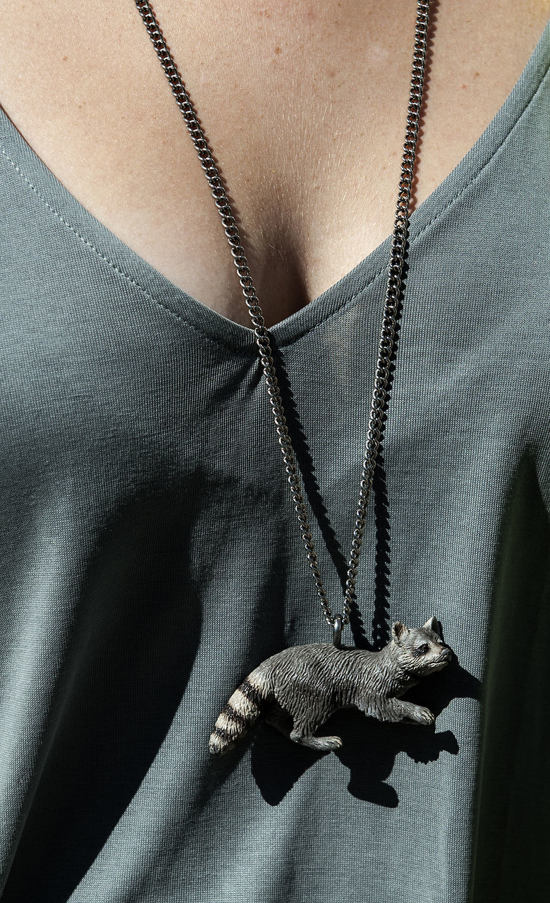 Midsection of woman wearing raccoon necklace