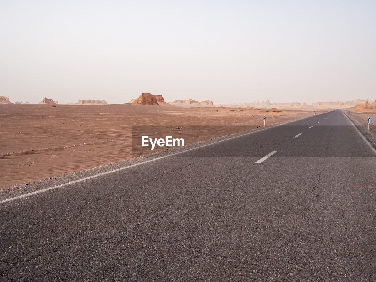 ROAD BY DESERT AGAINST SKY