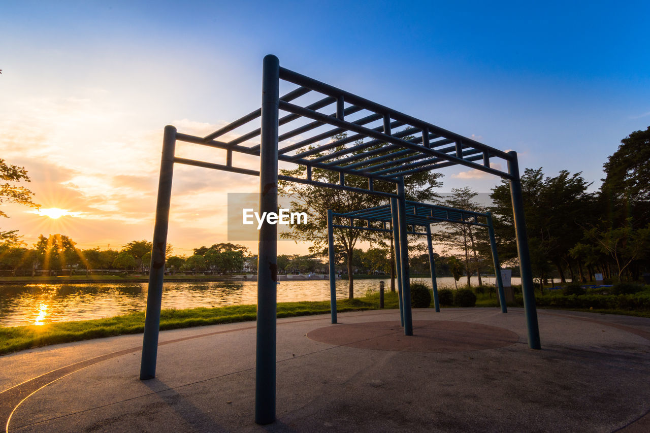 Ourdoor playground equipment in a sunset sky