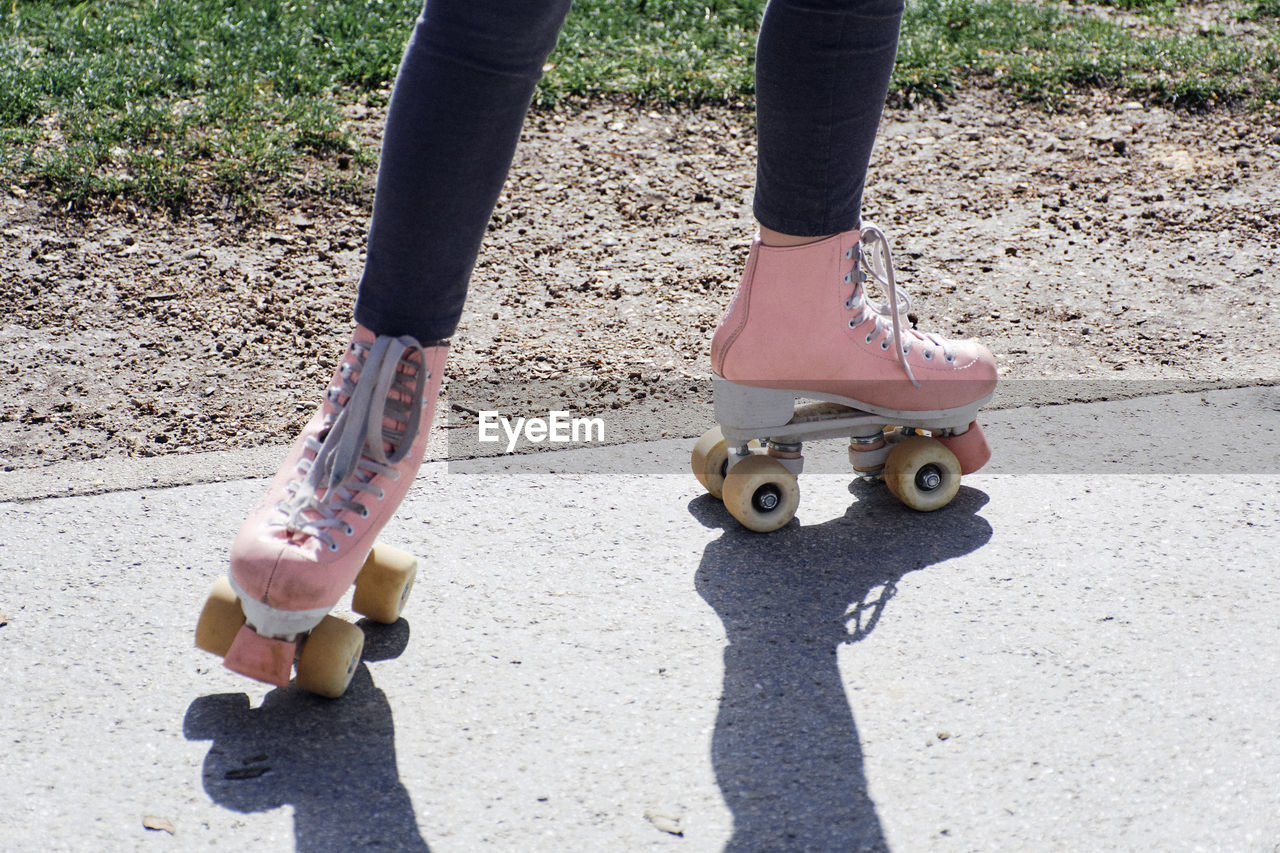Low section of girl on rollerskates.
