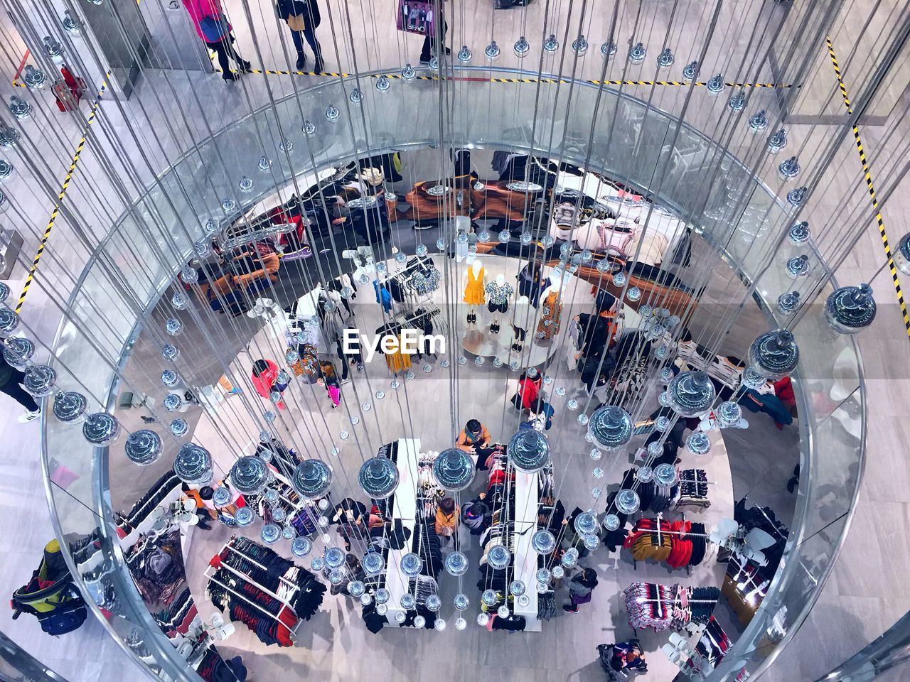 HIGH ANGLE VIEW OF PEOPLE WALKING IN MODERN OFFICE