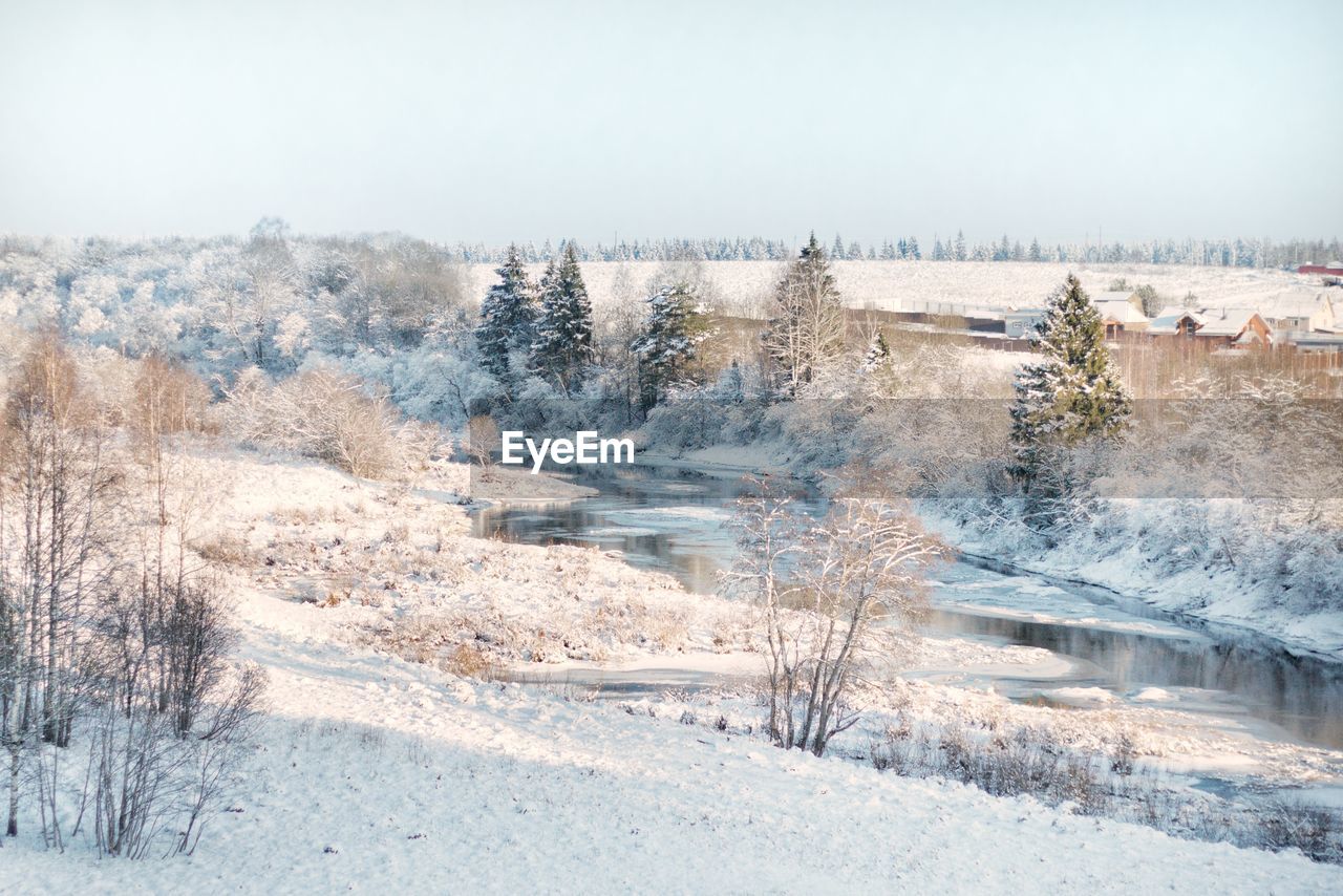 Scenic view of snow covered land against sky