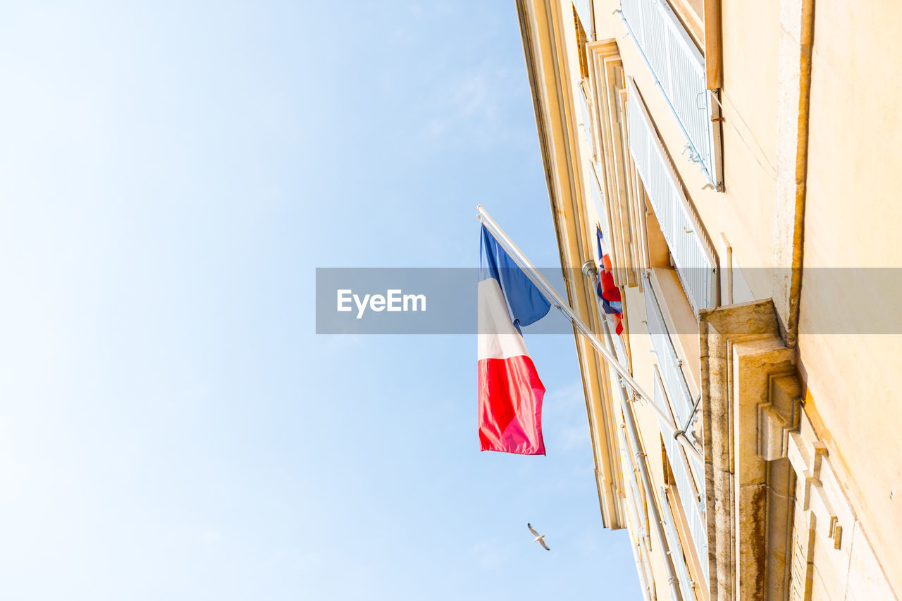 LOW ANGLE VIEW OF FLAGS AGAINST SKY