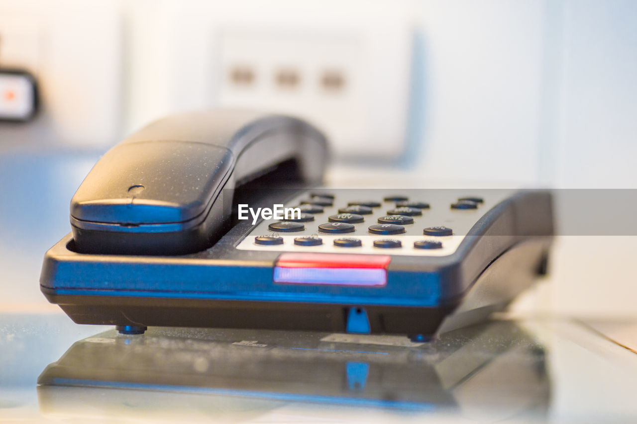 Close-up of telephone on table