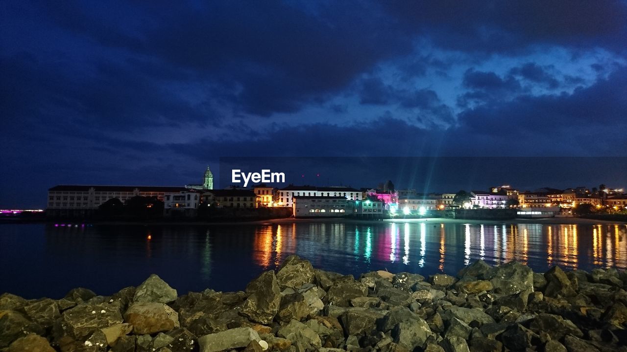 Illuminated city at waterfront