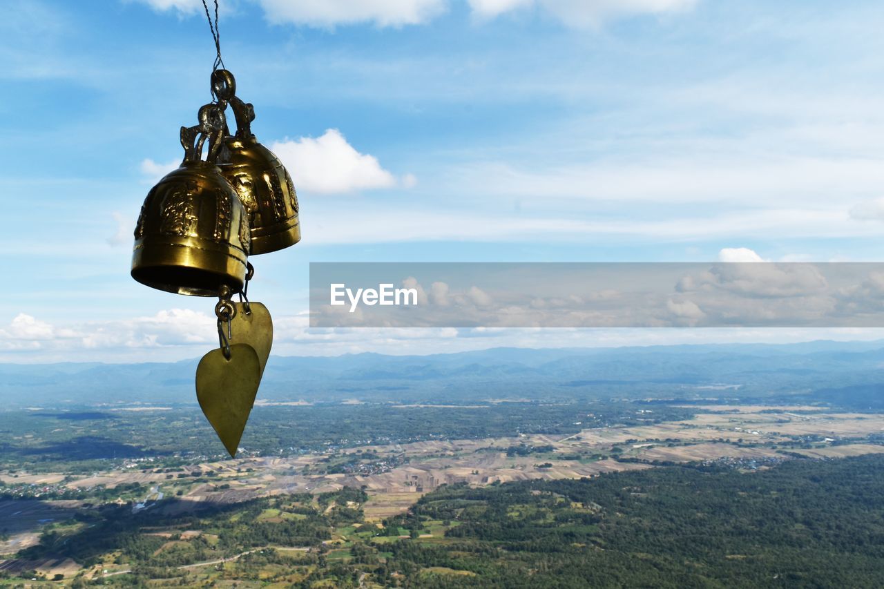 Bell and landscape against sky