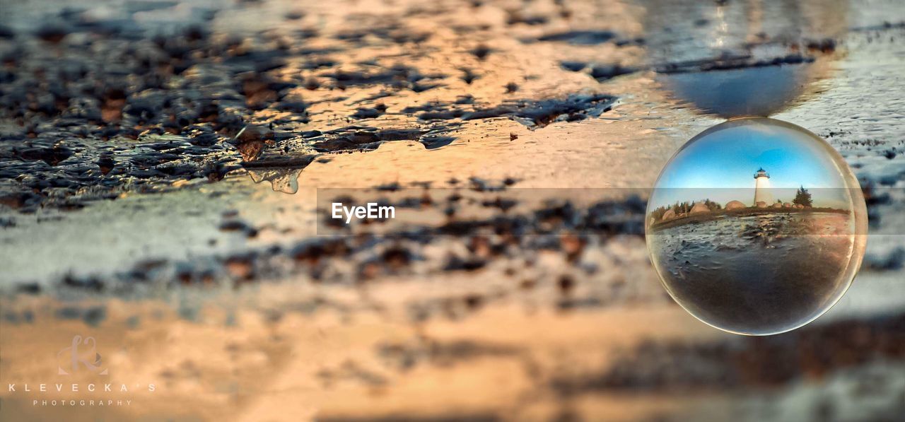 CLOSE-UP OF REFLECTION OF WATER IN BACKGROUND