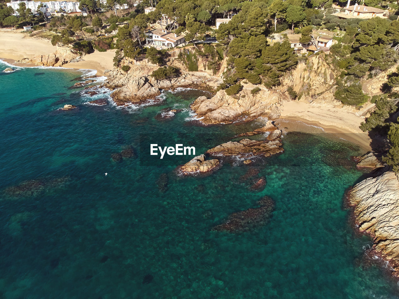 High angle view of rocks on sea shore