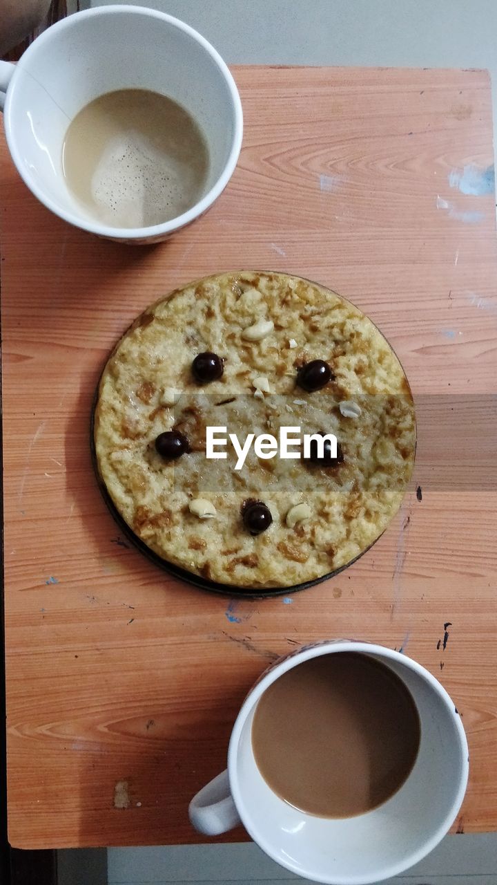 HIGH ANGLE VIEW OF COFFEE CUP AND COOKIES ON TABLE