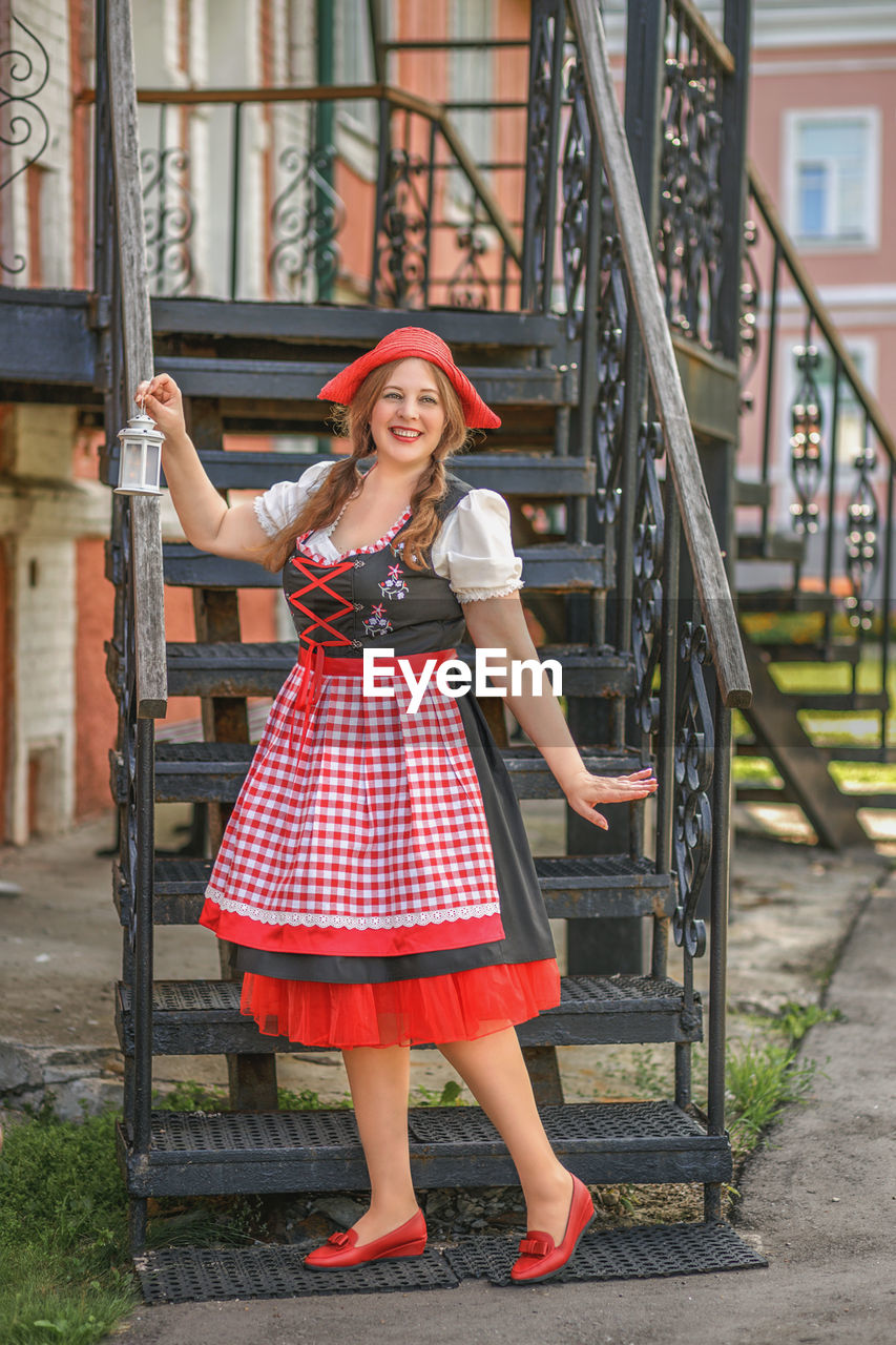 portrait of young woman standing on steps