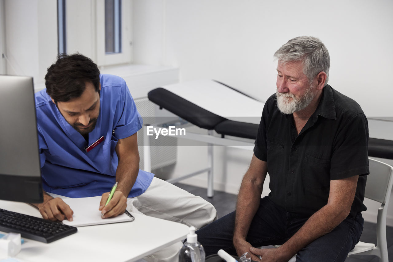 Male doctor and senior patient during appointment