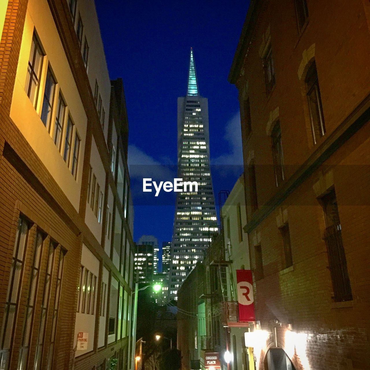 LOW ANGLE VIEW OF ILLUMINATED BUILDINGS AT NIGHT