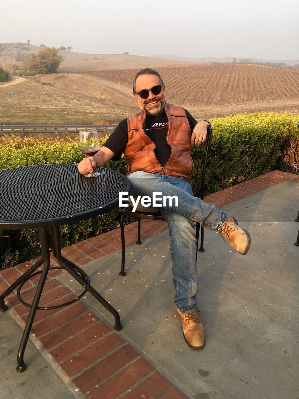 Portrait of smiling man sitting on chair outdoors