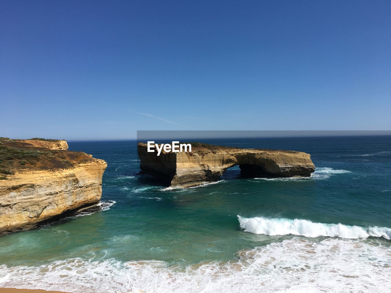 Scenic view of sea against clear blue sky