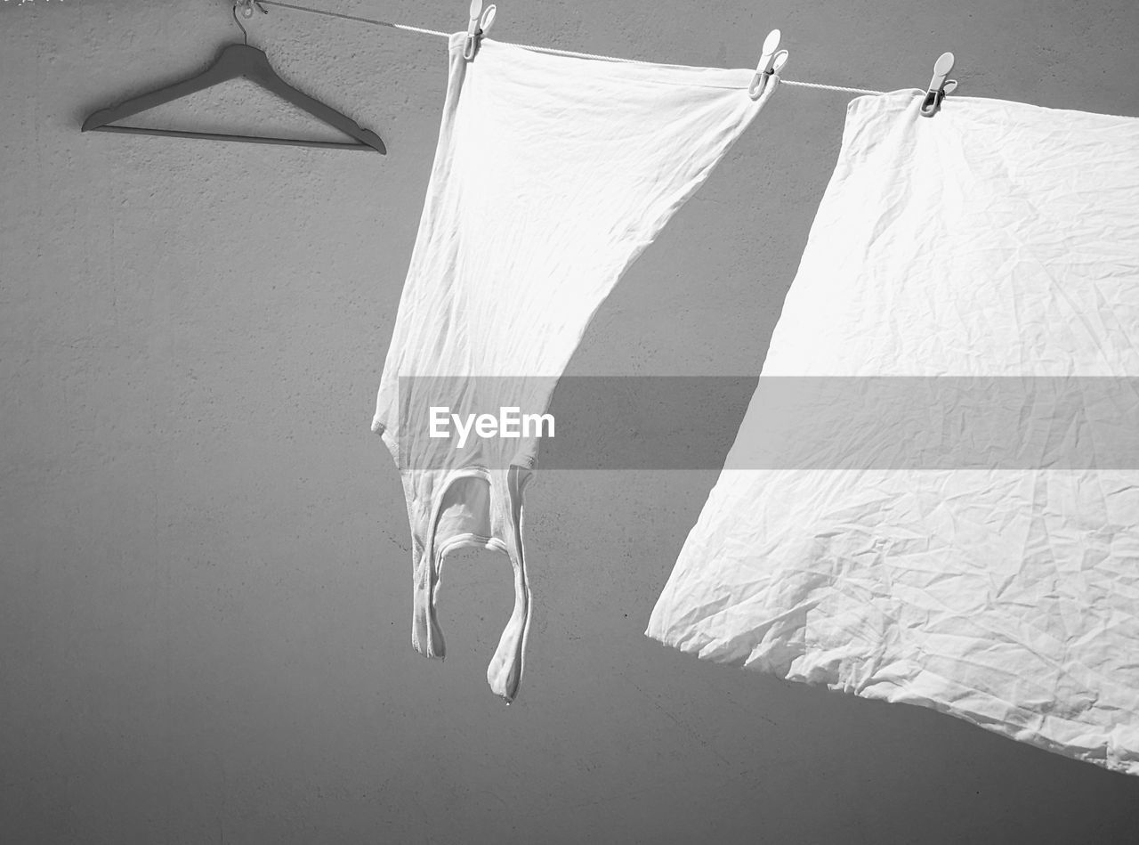 LOW SECTION OF WOMAN HANGING ON CEILING