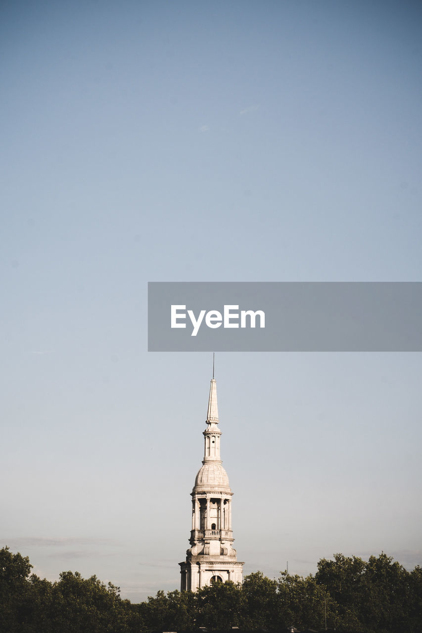 CHURCH TOWER AMIDST TREES AGAINST SKY