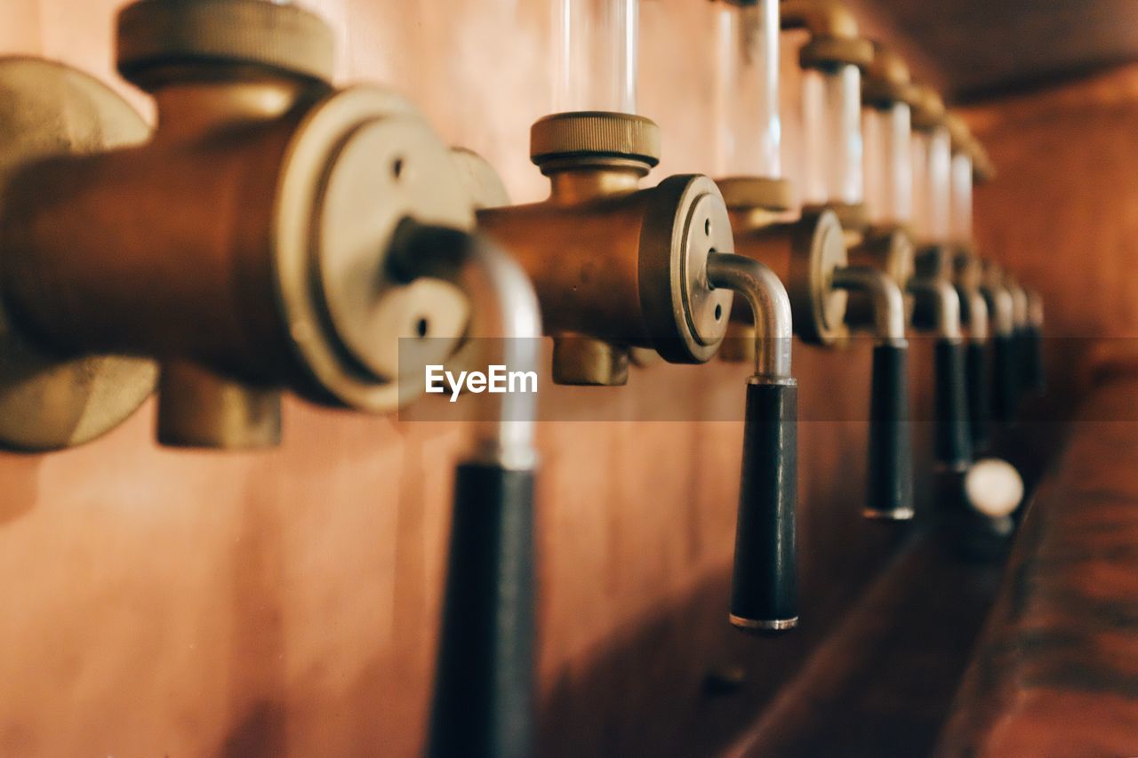 Close-up of beer taps at bar