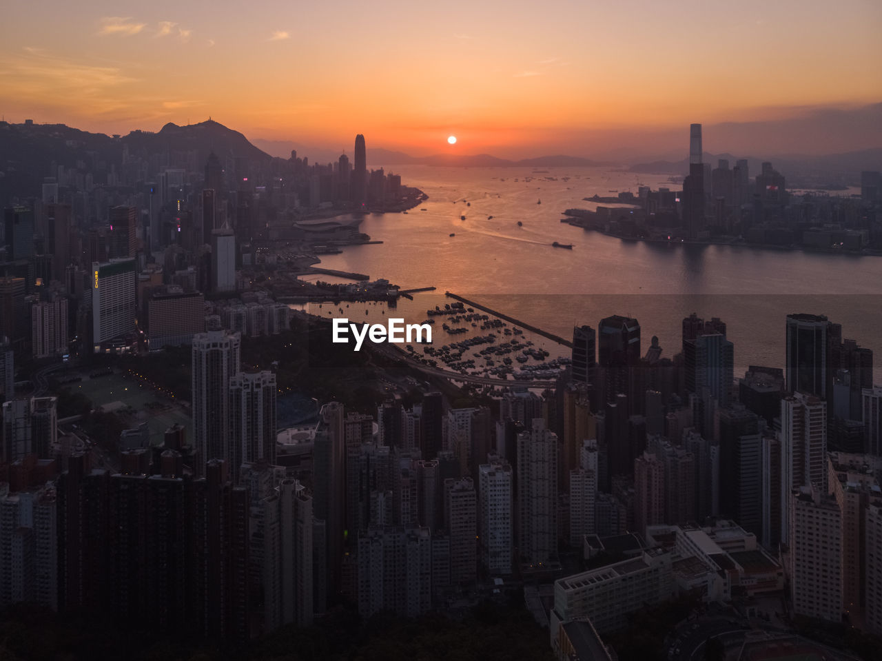 HIGH ANGLE VIEW OF BUILDINGS IN CITY DURING SUNSET