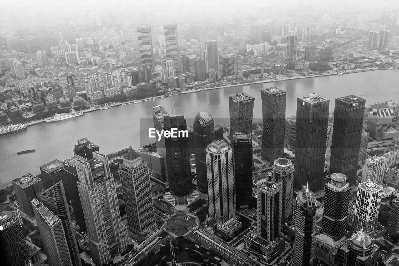 HIGH ANGLE VIEW OF BUILDINGS BY RIVER IN CITY