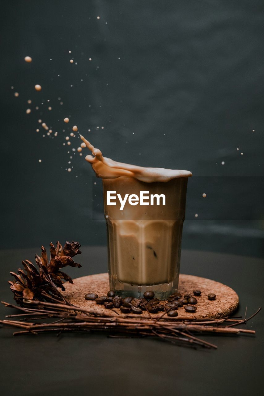 Close-up of coffee splashing in glass