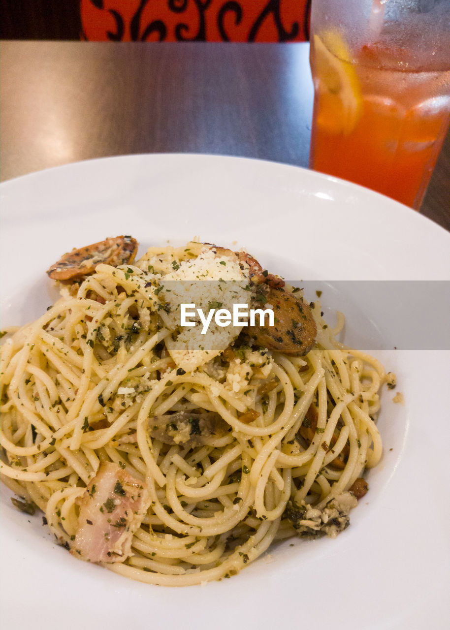 CLOSE-UP OF NOODLES SERVED ON TABLE