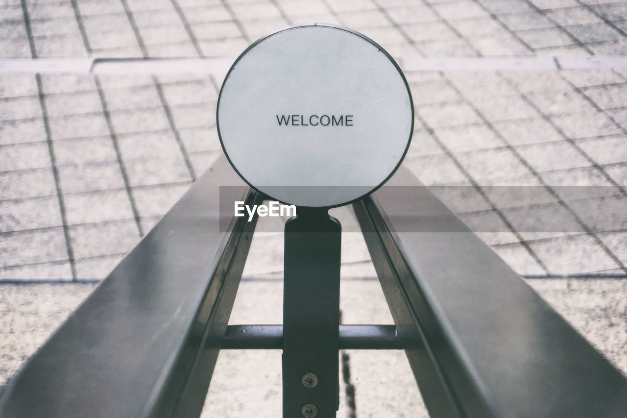 Close-up of welcome sign on metal