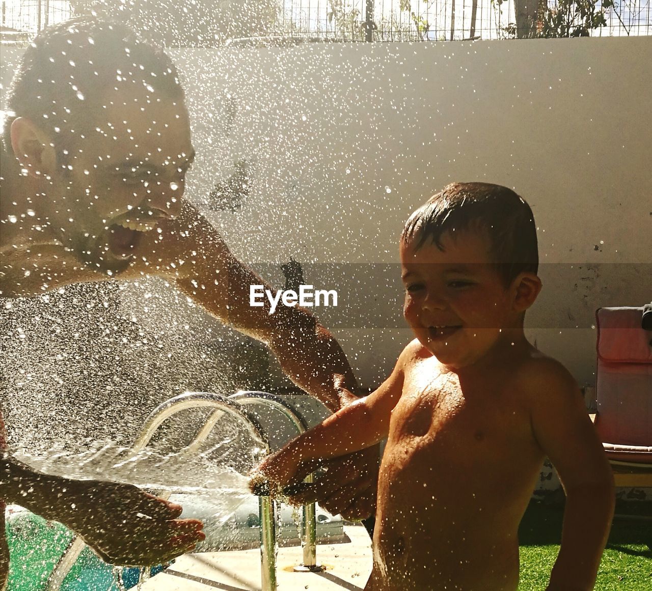 BOY PLAYING WITH WATER SPLASHING