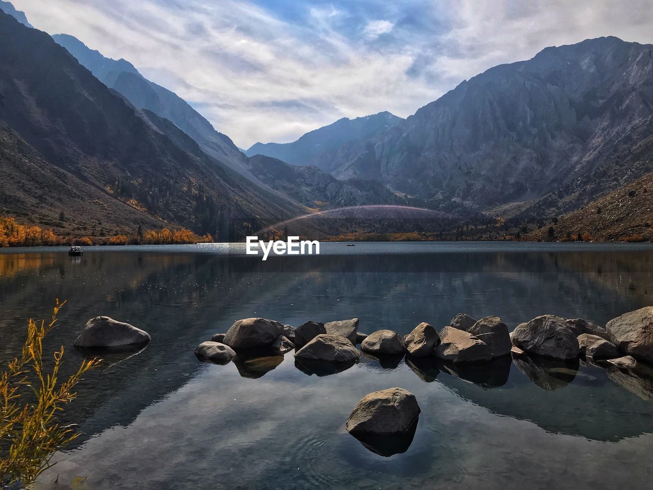 Scenic view of lake and mountains against sky