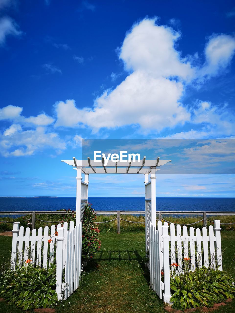 WOODEN POST ON BEACH AGAINST SKY