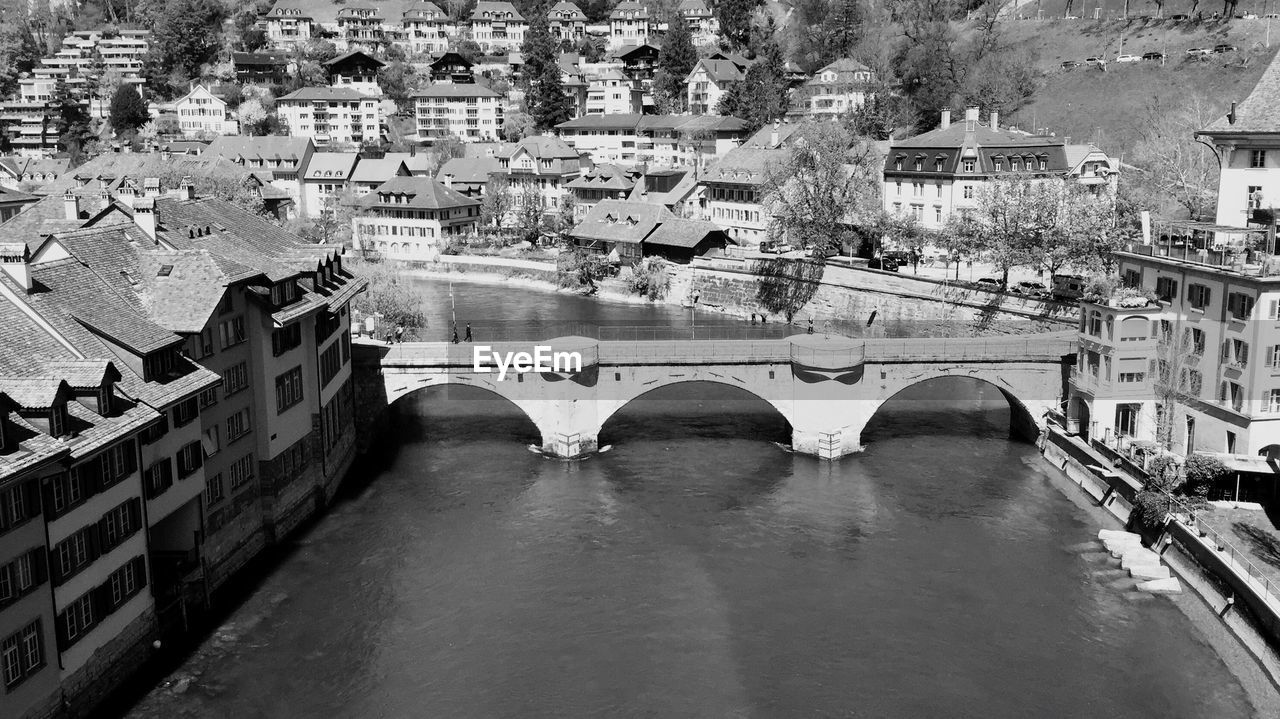 High angle view of arch bridge over river in town