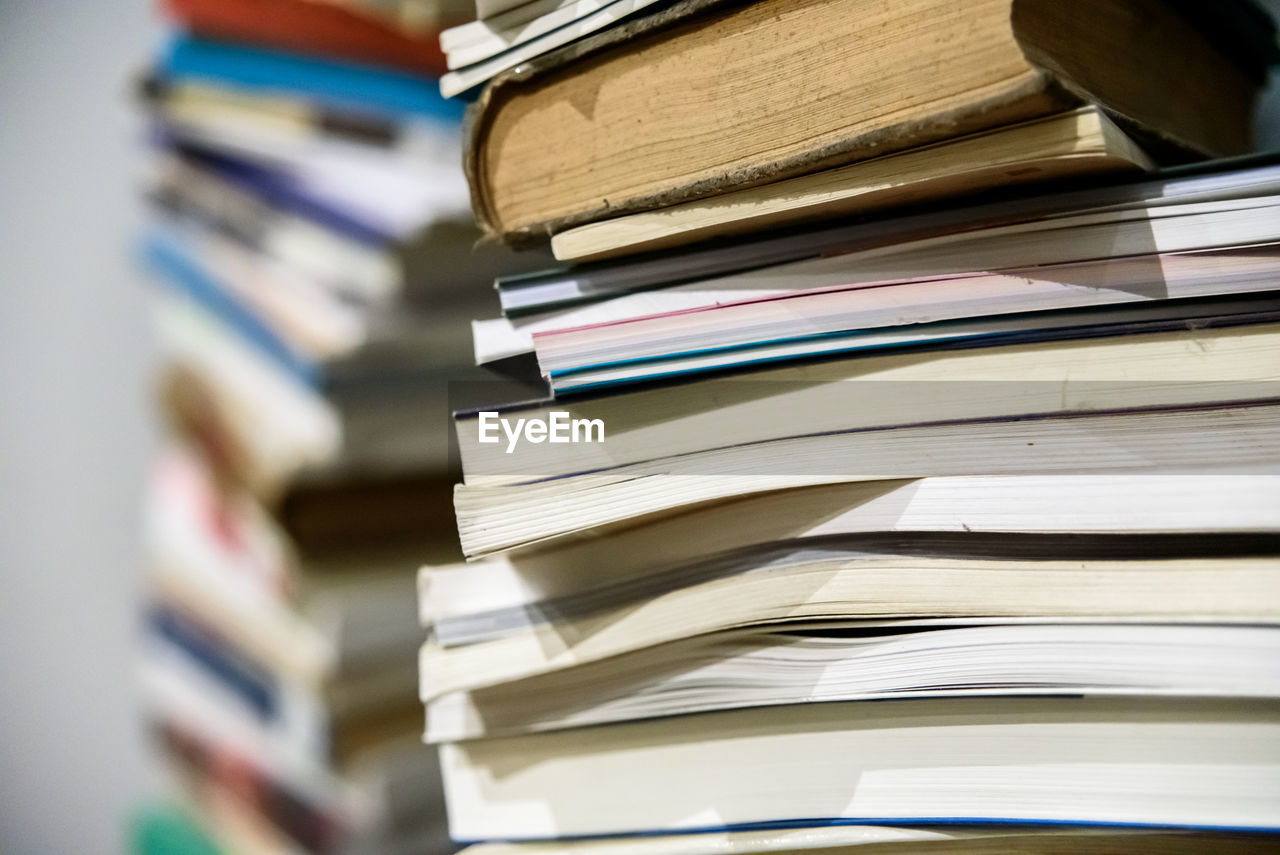 STACK OF BOOKS ON SHELF